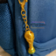 3D printed FIFA World Cup trophy keychain attached to a blue backpack zipper