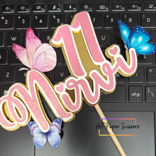 Personalized butterfly birthday cake topper with custom name, age 11, pink lettering and blue butterflies
